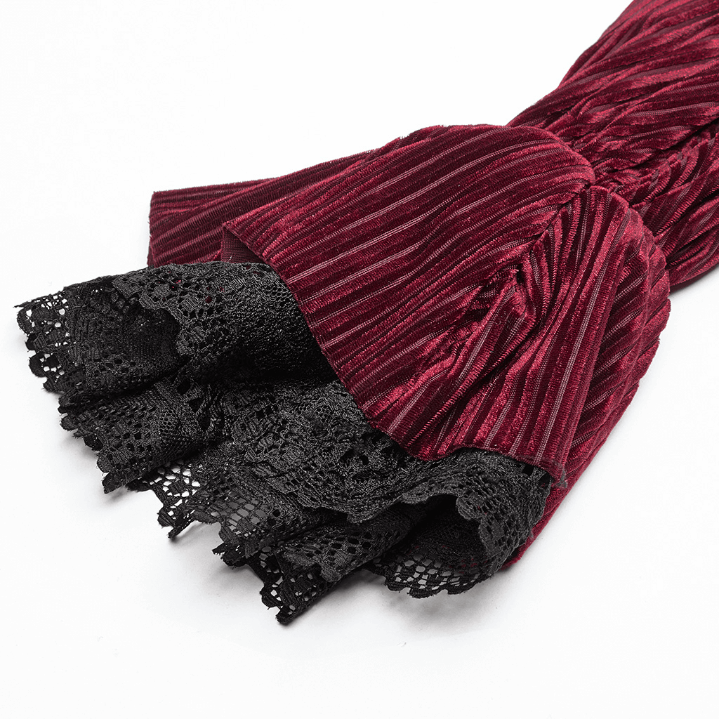Close-up of burgundy velvet shirt sleeve with black lace detail, showcasing gothic elegance and style.
