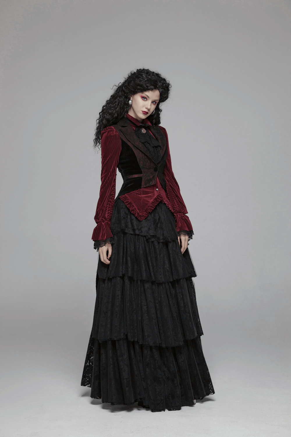 Elegant woman in a gothic burgundy velvet corset shirt and layered black skirt, showcasing Victorian style and lace details.