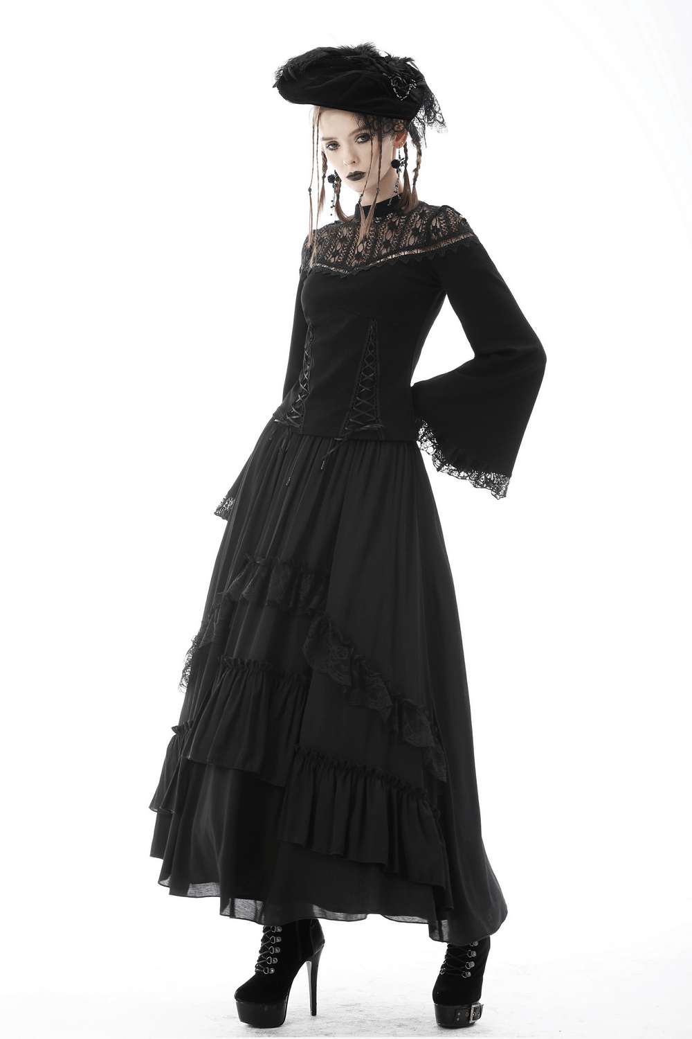Elegant black tiered maxi skirt with lace detail, paired with a stylish off-shoulder top and dramatic hat for a gothic look.