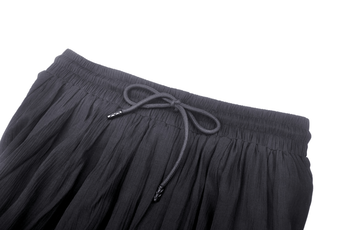 Close-up of a stylish black skirt featuring a drawstring waist for adjustable comfort and a chic look.