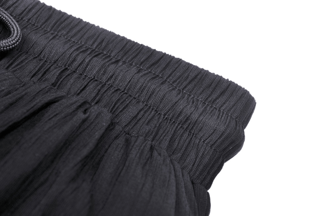 Close-up of the black waistband of an elegant women's tiered maxi skirt with an elastic design for a comfortable fit.