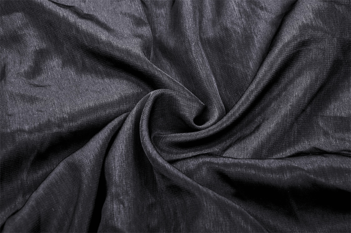Close-up view of luxurious black fabric, perfect for elegant clothing and stylish designs.