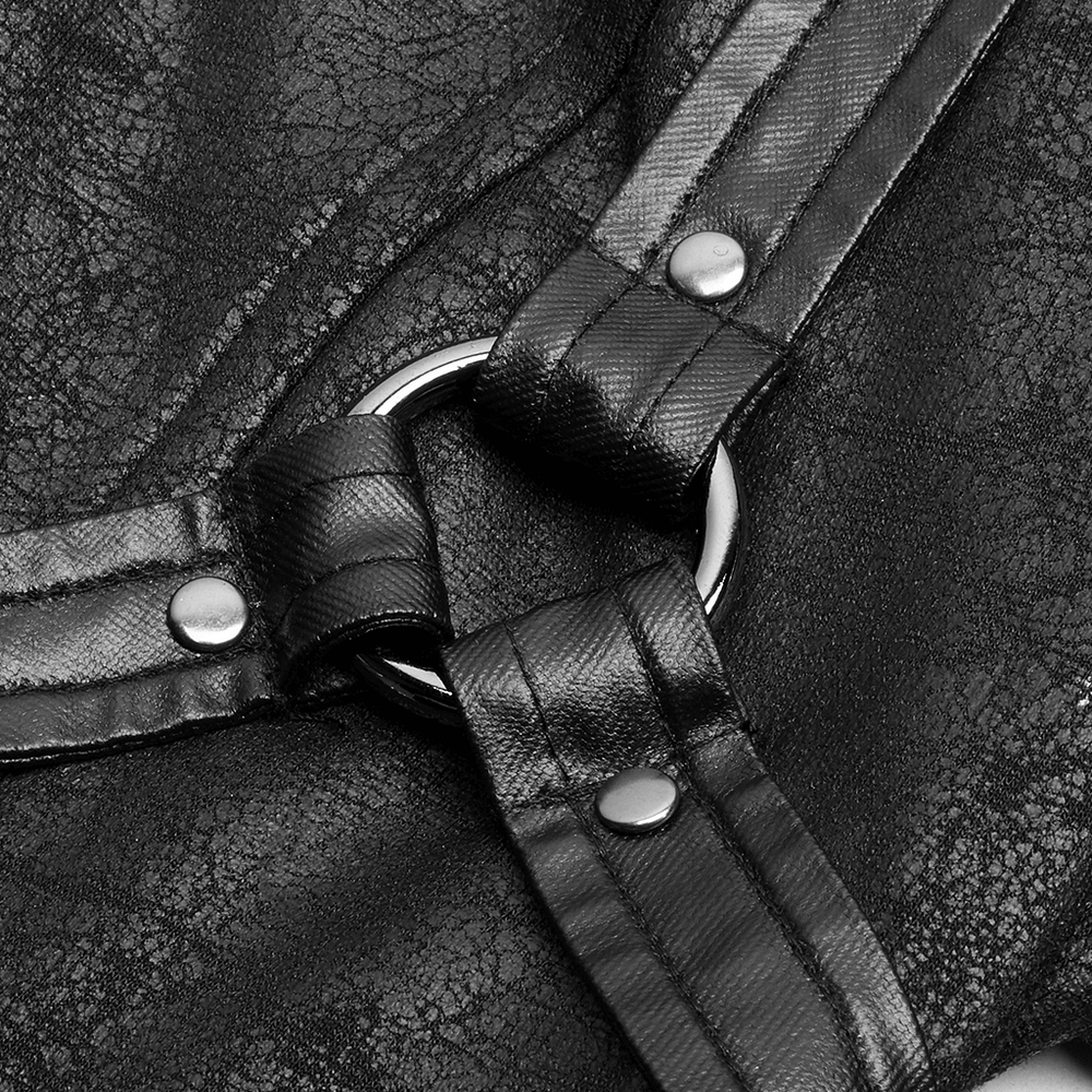 Close-up of embossed dark fabric and metal ring detail on punk full-length coat.