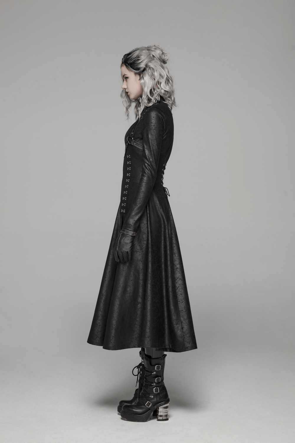 Side view of a model in an Embossed Dark Elegance Punk Full-Length Coat, showcasing its unique texture and slim fit design.