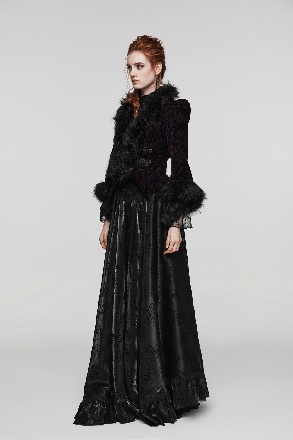 Gothic velvet jacket with fur detailing, exuding dark romance and elegance, paired with a flowing black skirt.