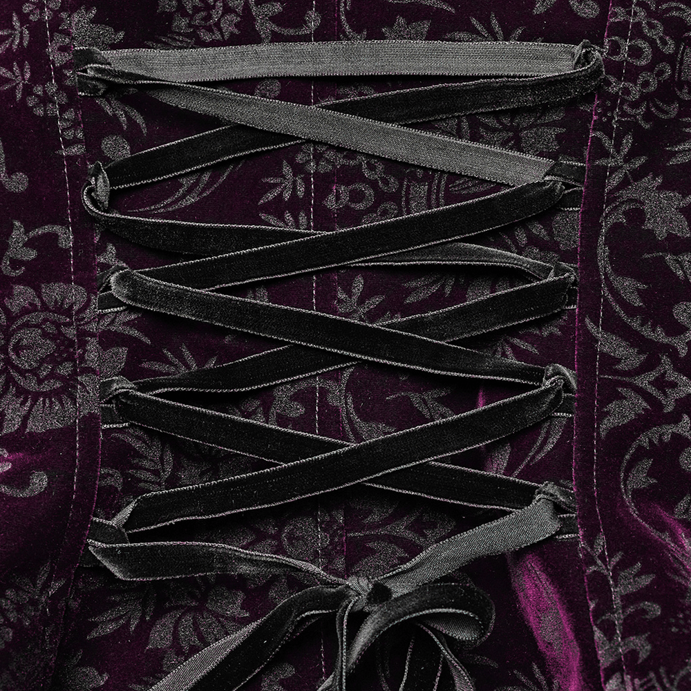 Close-up of embossed velvet gothic jacket with intricate lacing and floral pattern details.