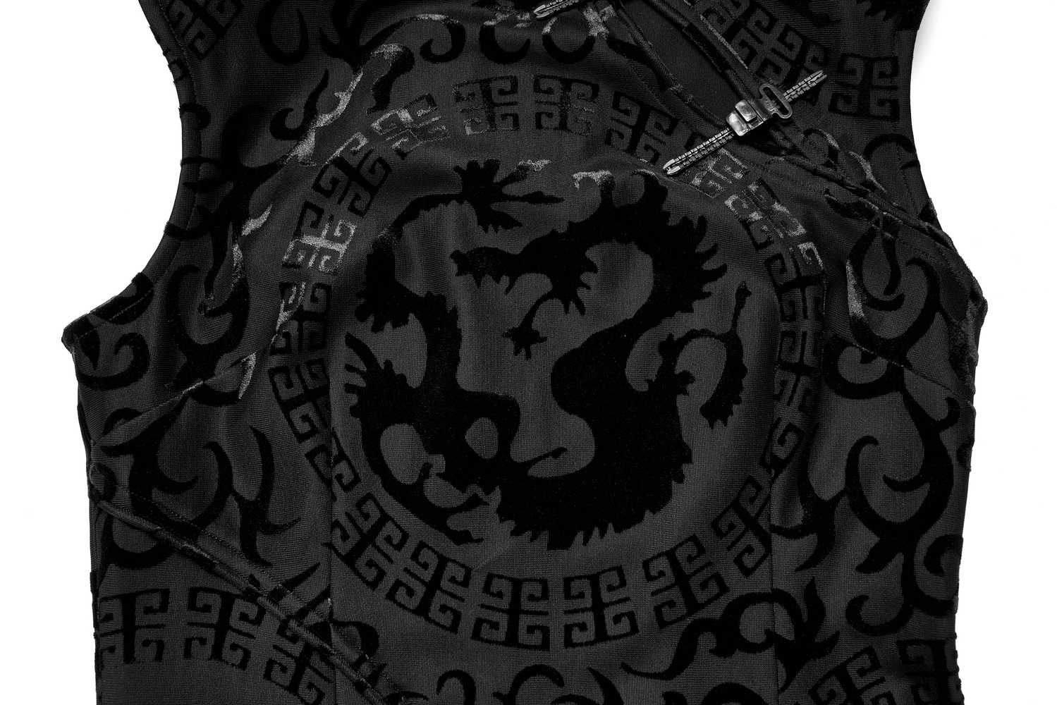 Close-up of the embroidered dragon design on a black stretch velvet dress with intricate patterns.