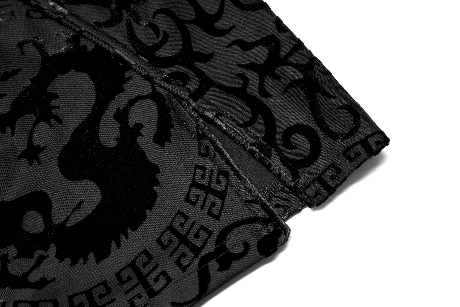 Close-up of the intricate burnt-flower Chinese dragon design on stretch velvet fabric for the A-line dress.