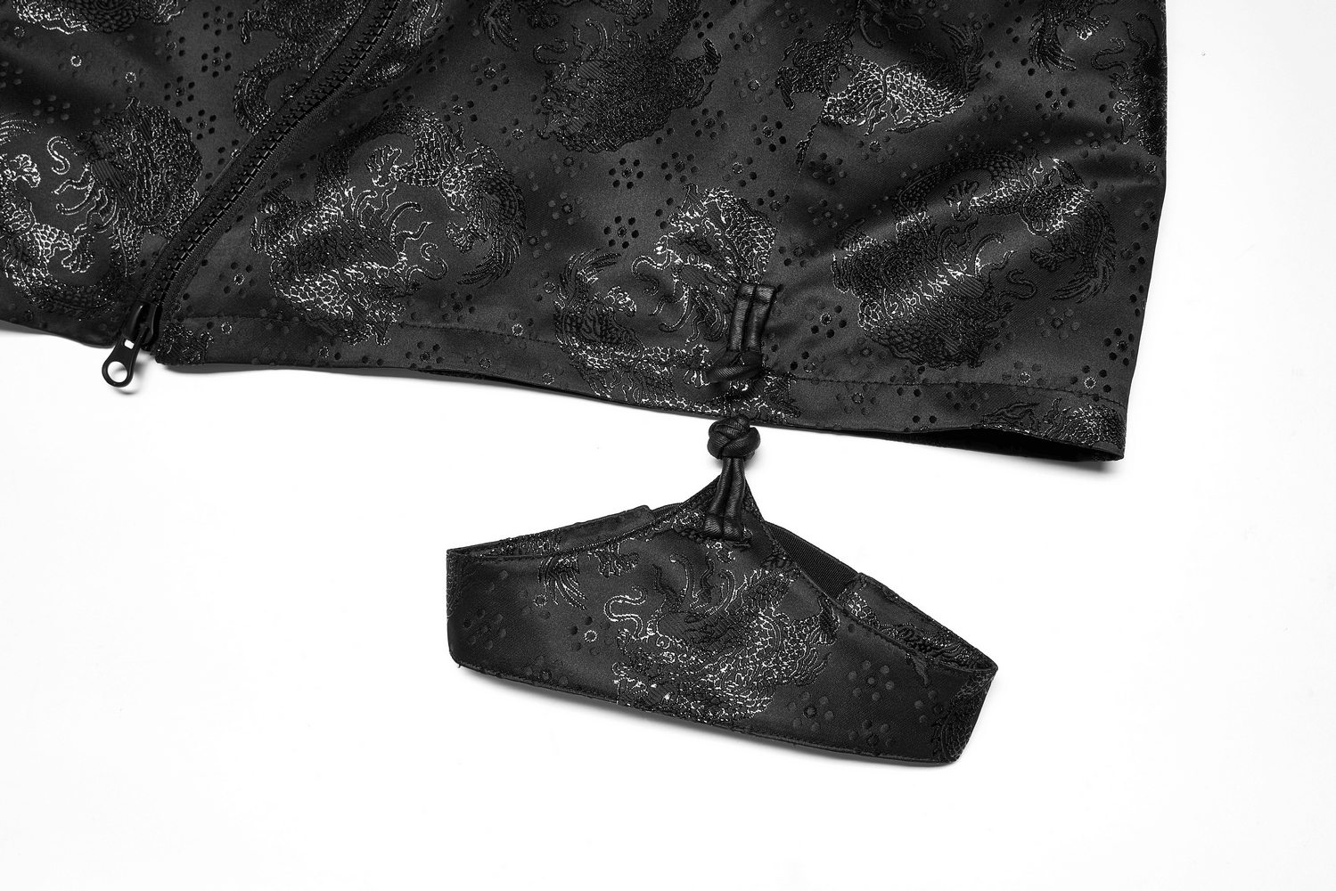 Close-up of black embroidered dragon jacquard skirt with detachable garter loops.