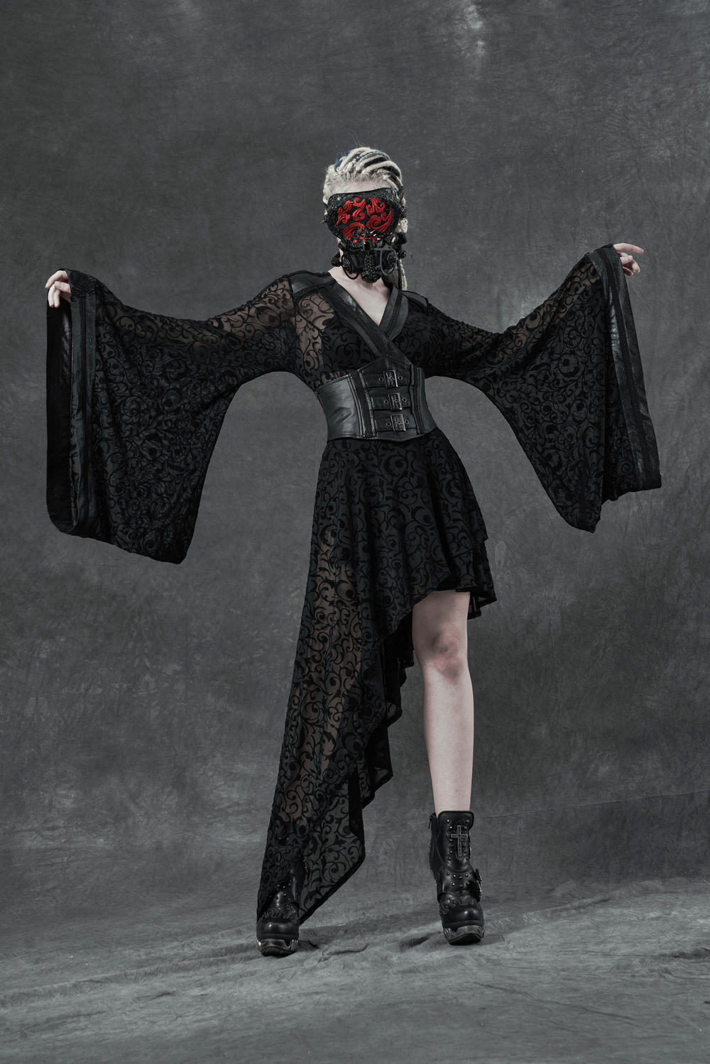 Gothic asymmetrical kimono dress with embroidered accents and detachable belt, showcased in moody ambiance.