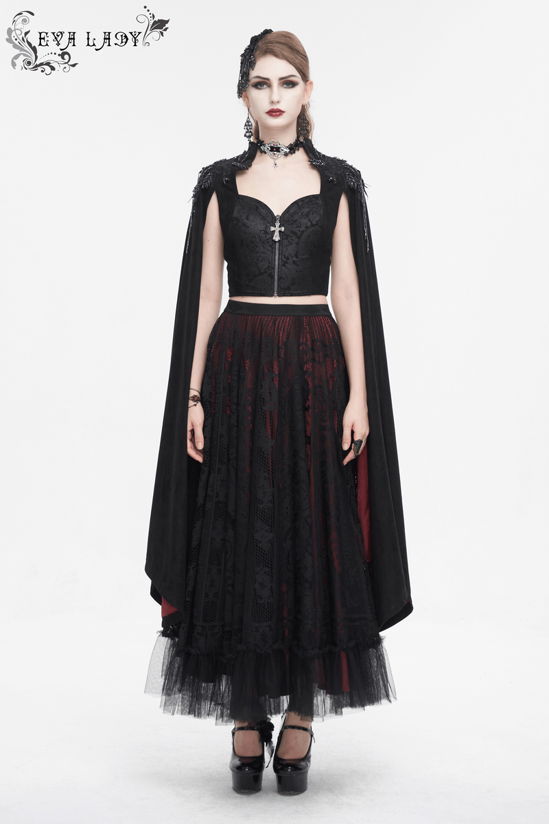 Gothic-inspired women's outfit featuring a black cropped top with cape and flowing skirt for dark elegance.