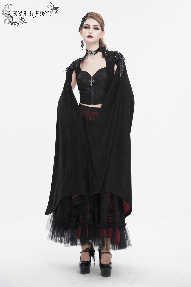 Gothic elegance: model in black cape, corset, layered skirt, exuding alternative fashion vibes.
