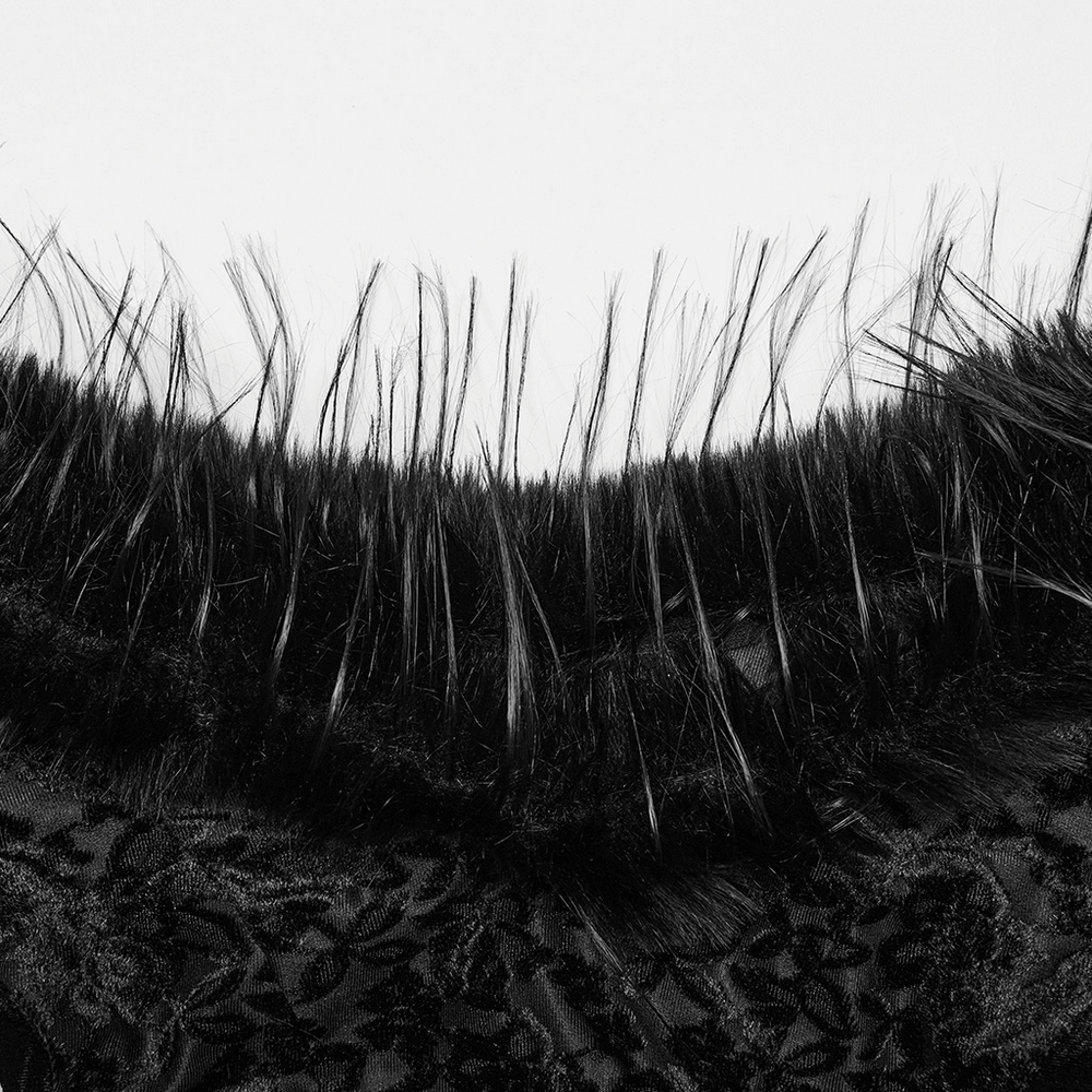 Close-up of the elegant fur trim on a gothic dress, showcasing its delicate texture and dark allure.