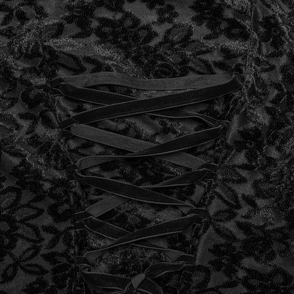 Close-up of gothic dress fabric with floral pattern and lace-up detailing in black velvet, exuding dark elegance.