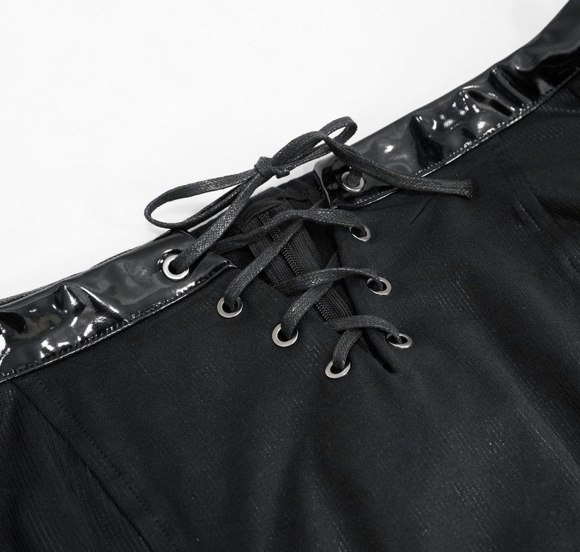 Close-up of the lace-up detail on a black gothic crop top, featuring sleek fabric and stylish drawstrings.