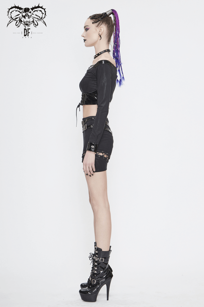 Side view of a woman in an enchanting off-shoulder black crop top and gothic punk style shorts, showcasing a trendy look.