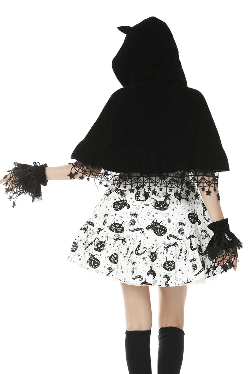 Back view of a model wearing a black velvet cat ear cape with lace details over a playful cat print dress.