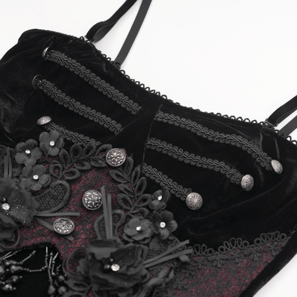 Close-up of dark velvet maxi dress with beaded lace appliques and gothic floral accents.