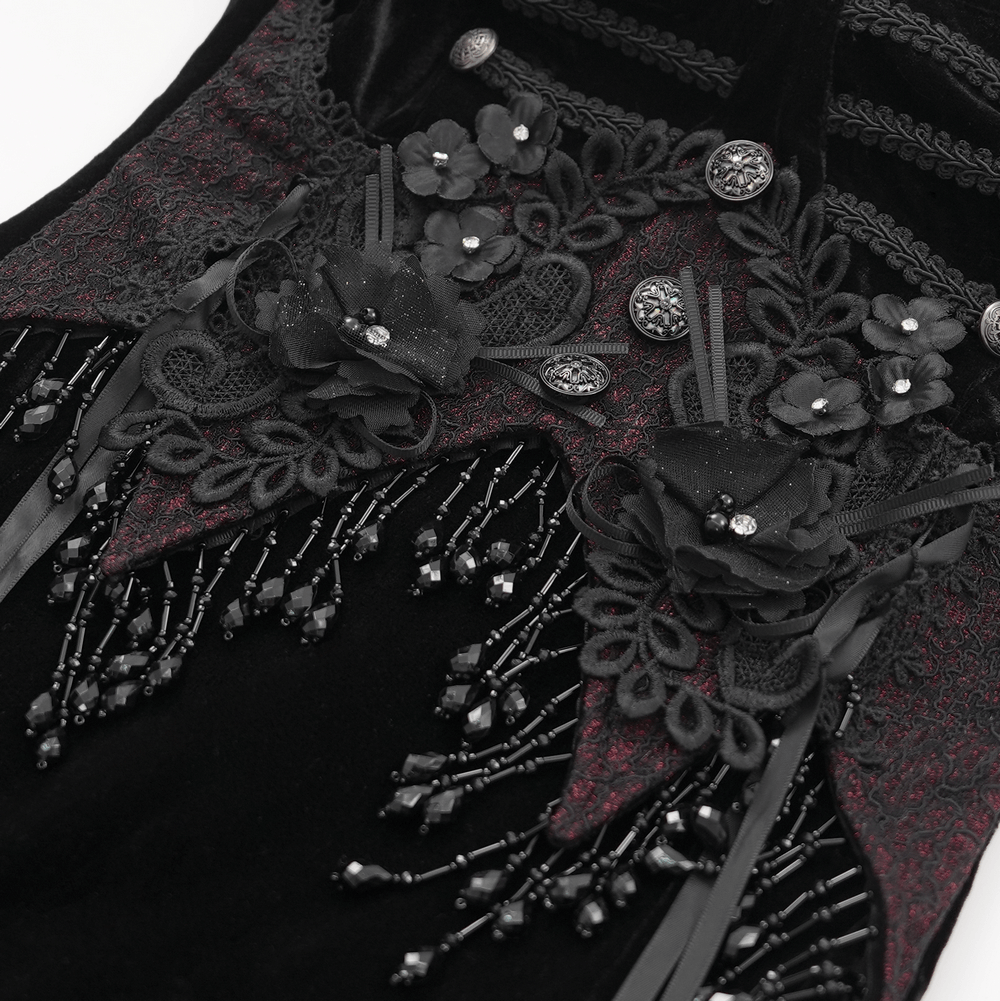 Detailed view of black velvet maxi dress with gothic floral beaded lace appliques and ribbons.