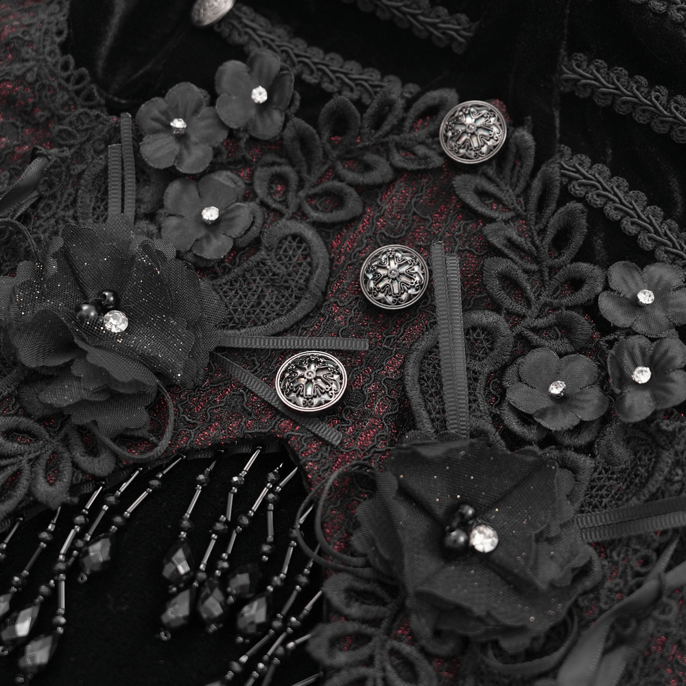 Close-up of intricate beaded lace appliques and floral accents on a black velvet dress.