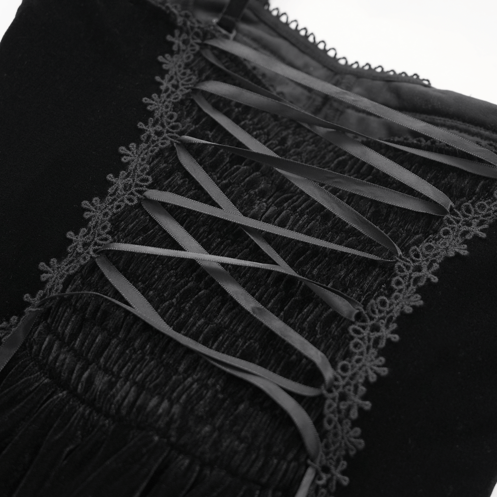 Close-up of black velvet dress featuring delicate lace and ribbon detailing for a gothic-inspired look.