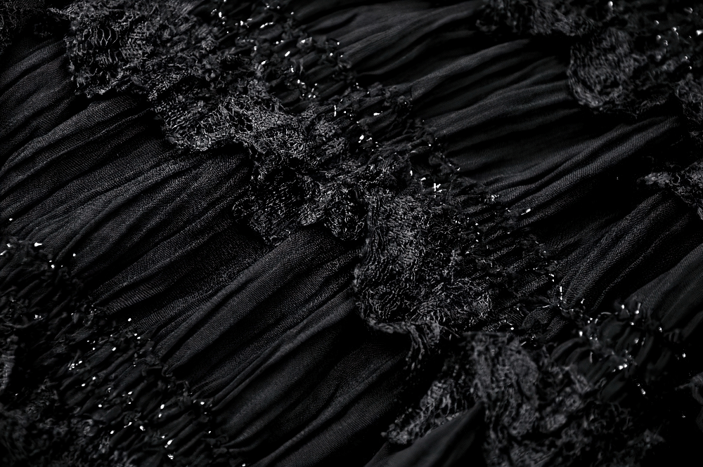 Close-up of elegant black lace trim and textured layers on a Gothic lace dress, showcasing dark elegance.