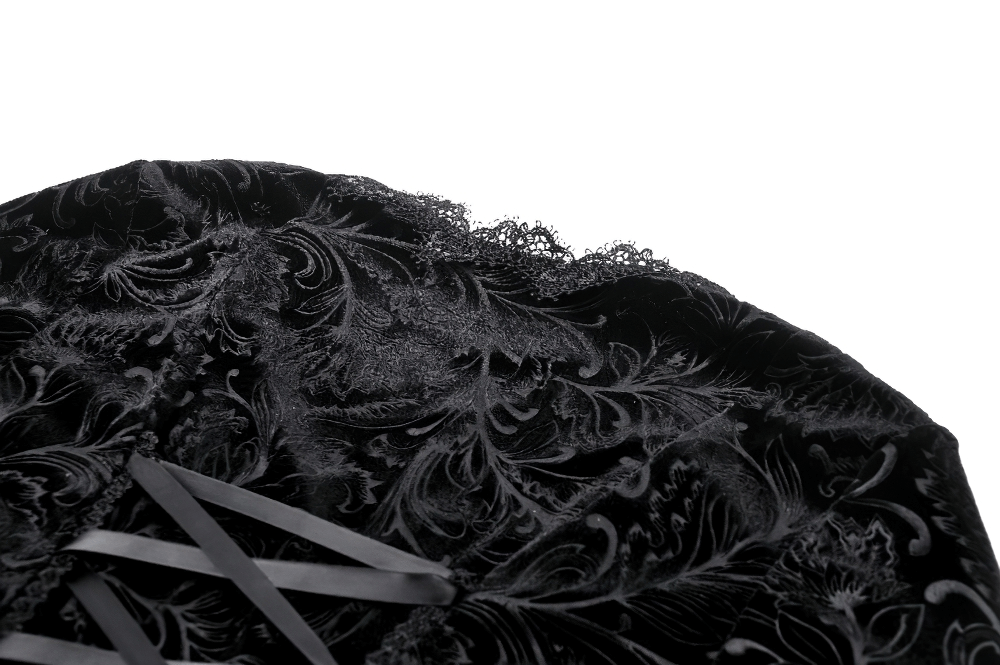 Close-up of black lace trim and elegant velvet fabric showcasing intricate floral designs.