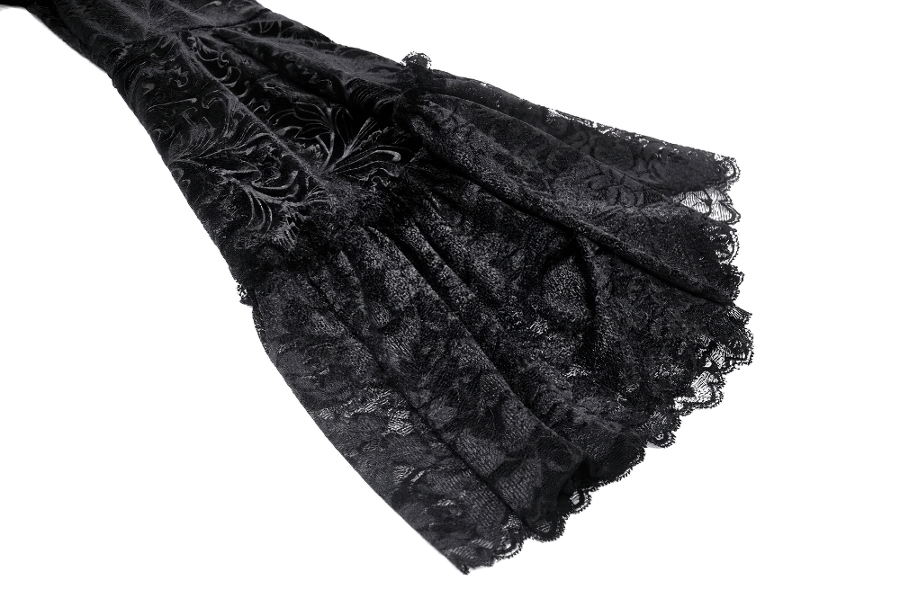 Close-up of the flowing black lace trim with intricate floral patterns on a Gothic lace dress.