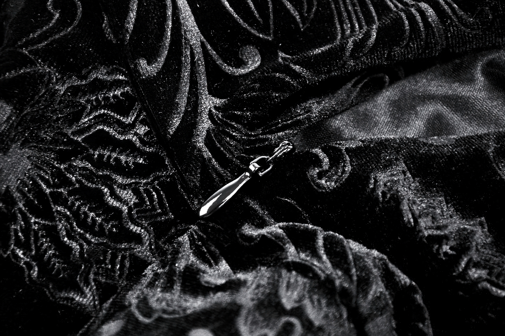 Close-up of intricate black lace fabric, showcasing elegant details ideal for a stylish gothic dress.