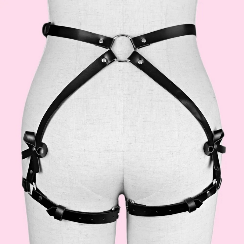 Black PU leather leg garter harness for ladies highlighting curves, ideal gothic accessory for bold fashion choices.