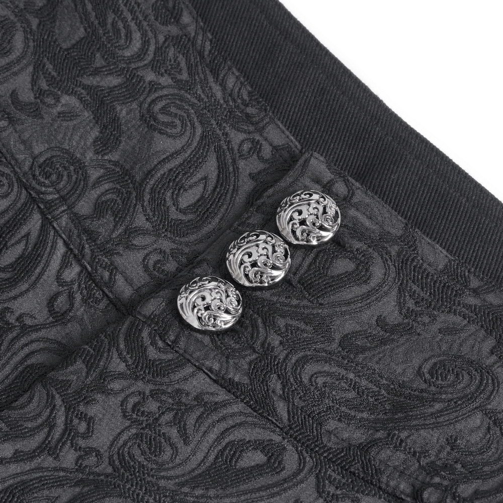 Close-up of elegant black trousers showcasing intricate embroidery and stylish decorative buttons