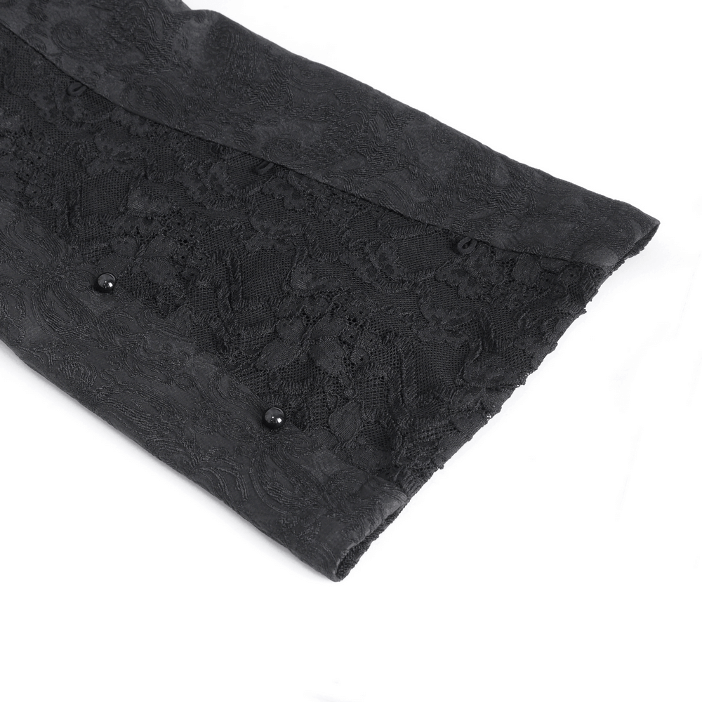 Elegant black trousers detail featuring floral lace and bead embellishments for a sophisticated evening look.