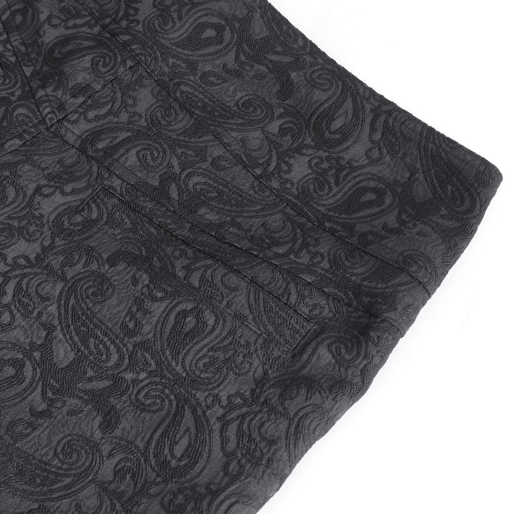 Close-up of exquisite black floral embroidered trousers with elegant paisley pattern.