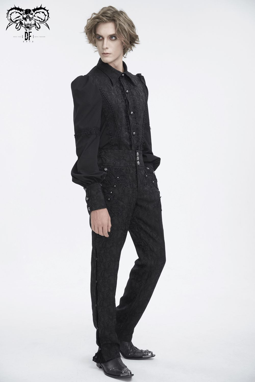 Chic model flaunting elegant black floral embroidered trousers with lace and a stylish black shirt.