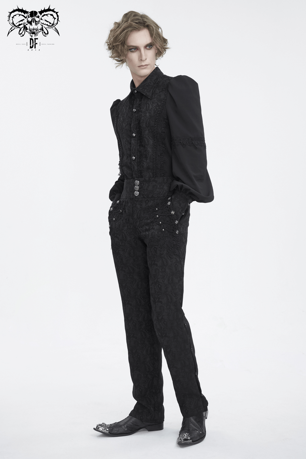 Elegant model in black floral embroidered trousers and lace shirt, showcasing a chic evening look.