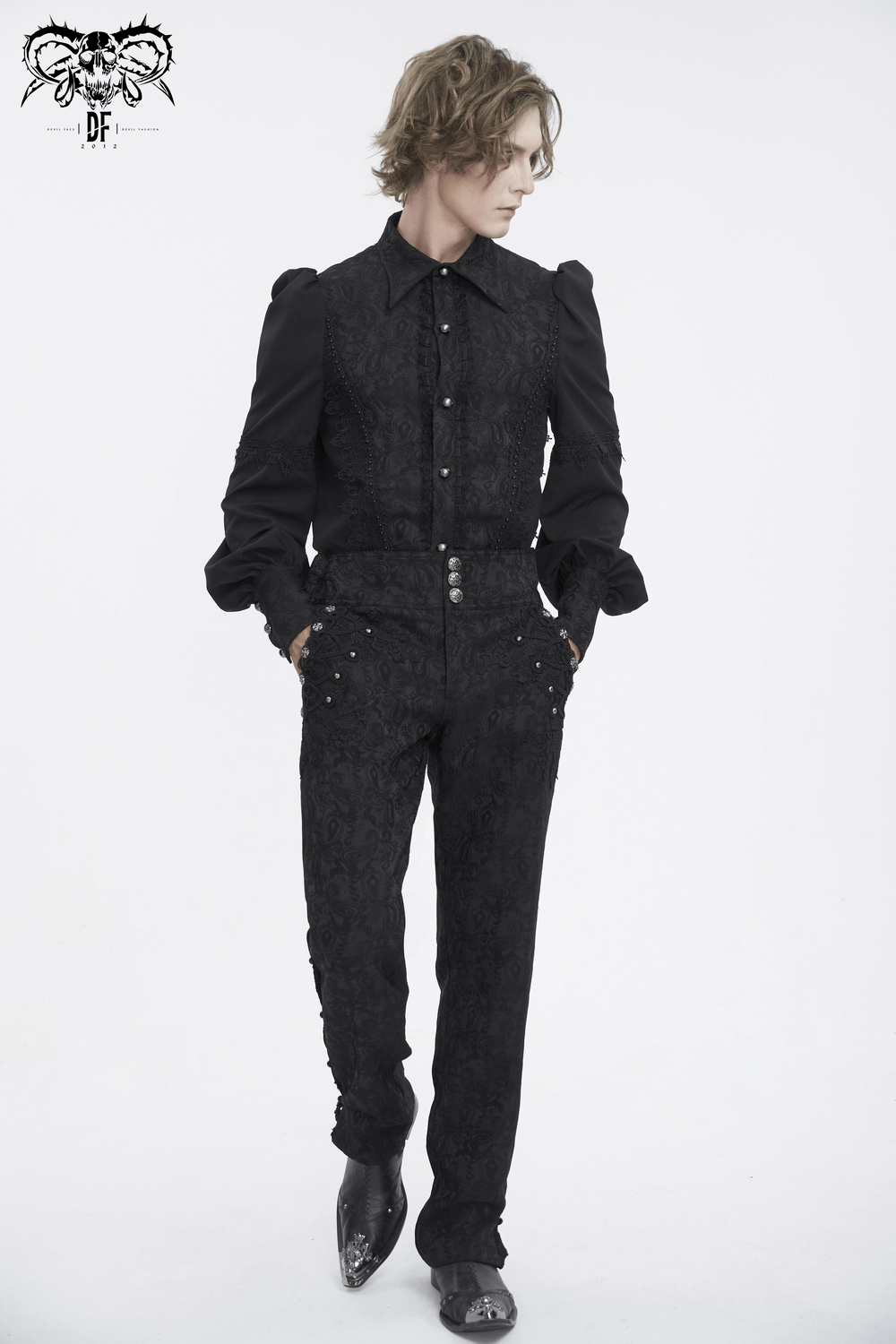 Chic model showcasing exquisite black floral embroidered trousers and matching top, perfect for elegant evenings.