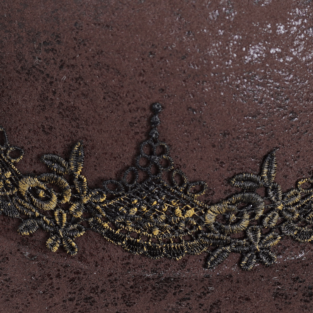 Close-up of intricate black lace detailing on a Victorian brown tricorn hat, showcasing elegance and gothic style.