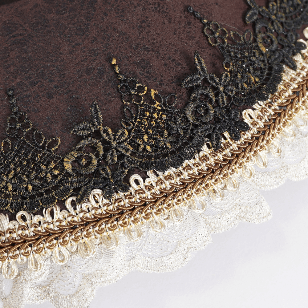 Intricate lace detailing on a Victorian brown tricorn hat with golden accents and elegant black lace.