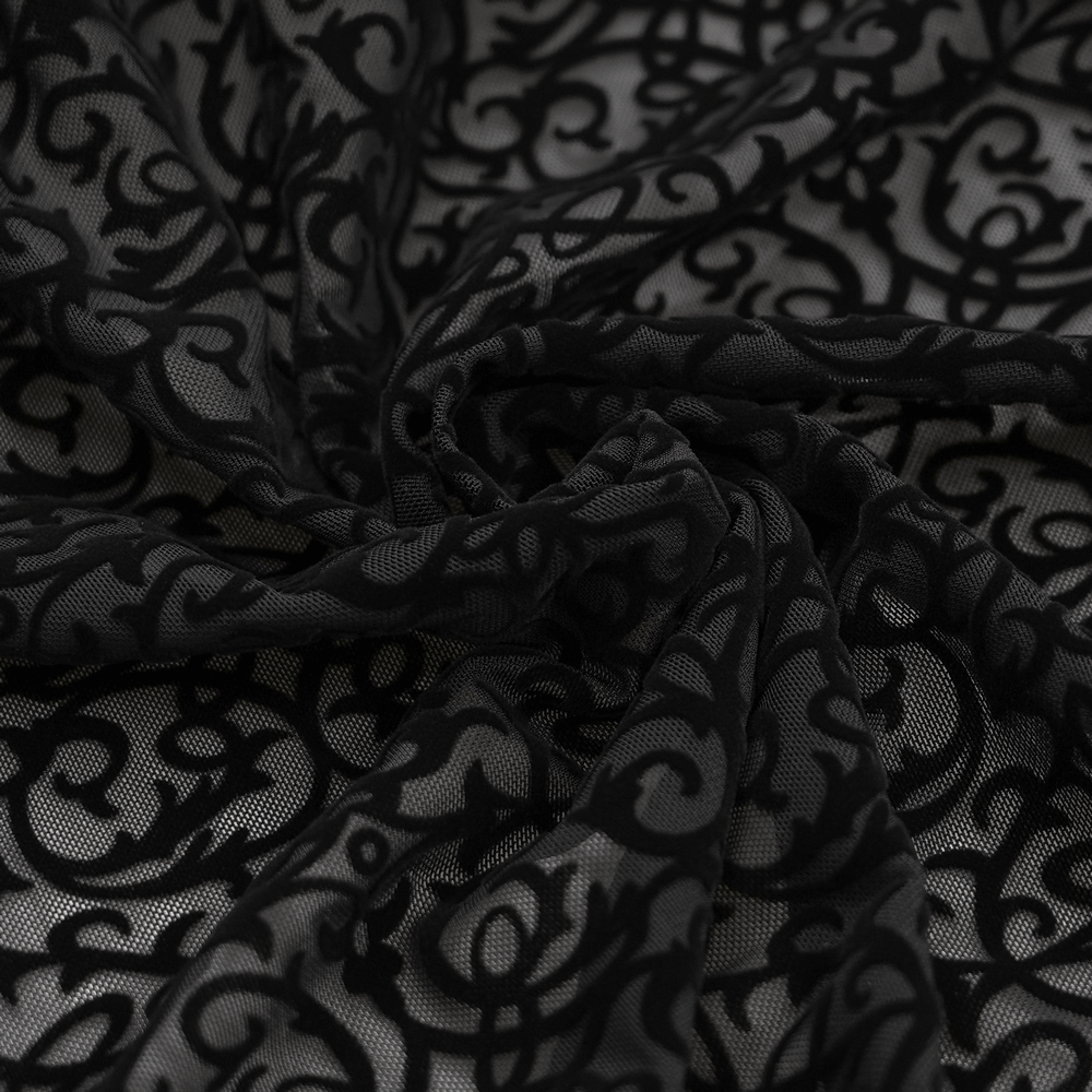 Close-up of luxurious black lace fabric with intricate floral patterns, perfect for elegant wide-leg trousers.