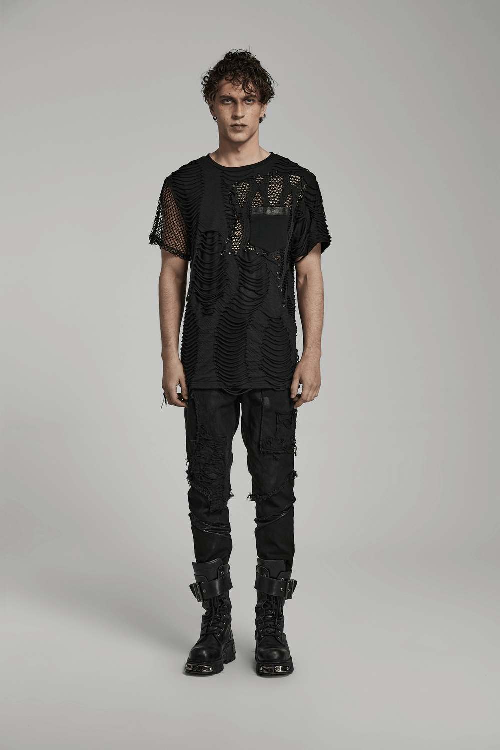 Edgy punk t-shirt with mesh splice design, featuring bold cutouts and eyelets, worn by a model.