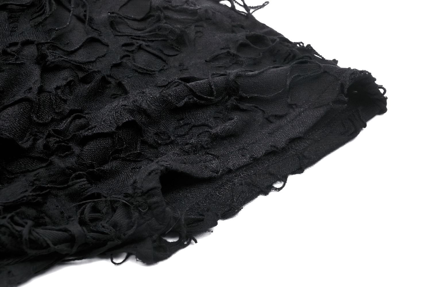 Close-up of black asymmetrical ripped fabric, showcasing distressed mesh and lace-up detailing for edgy fashion.