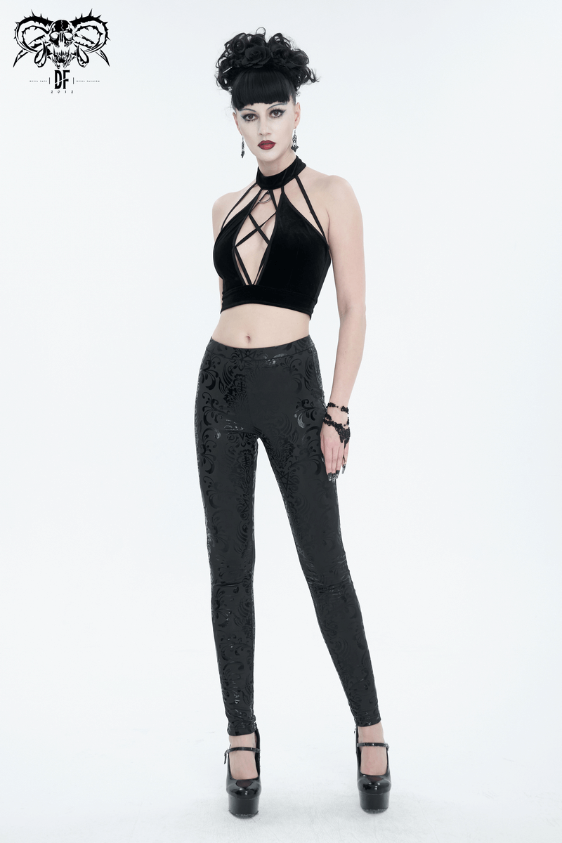Gothic style model in black velvet crop top and patterned leggings, showcasing chic and edgy fashion.