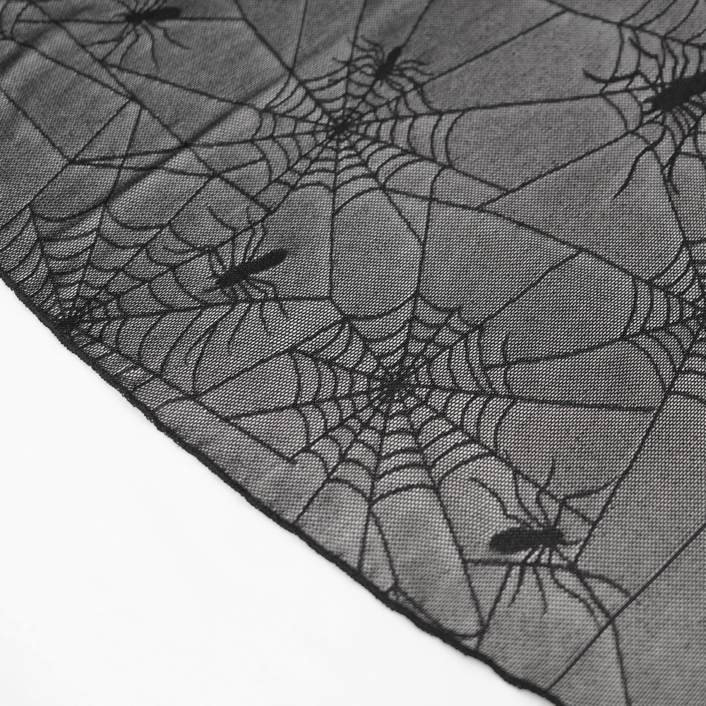 Close-up of black fabric featuring a spider web motif, perfect for gothic fashion.