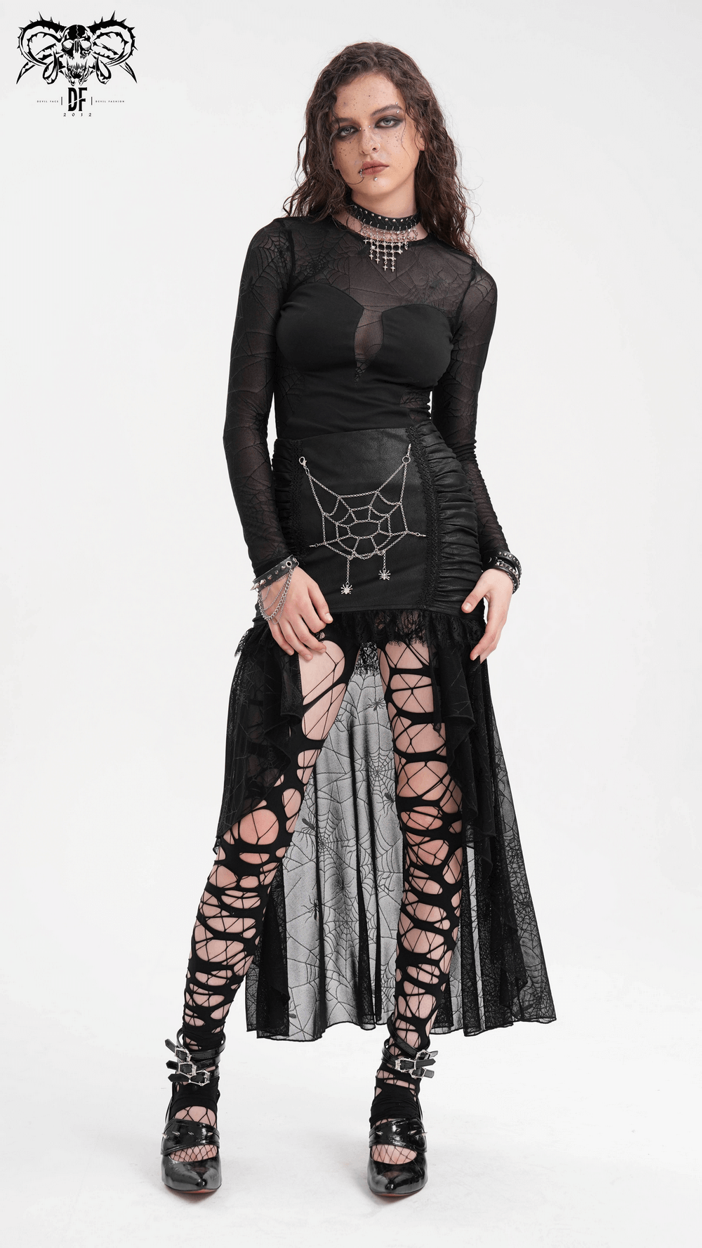 Gothic fashion model showcasing a black spider web asymmetric skirt with lace details and stylish lace-up leggings.