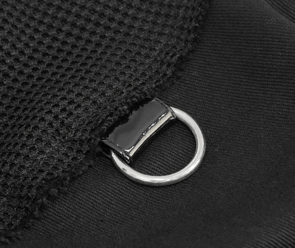 Close-up of a silver metal ring detail on a black fashion vest, showcasing stylish punk accent.