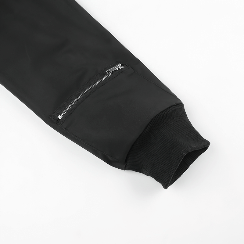 Close-up of sleeve detailing of black zipper cropped top featuring unique pockets, perfect for punk style outfits.