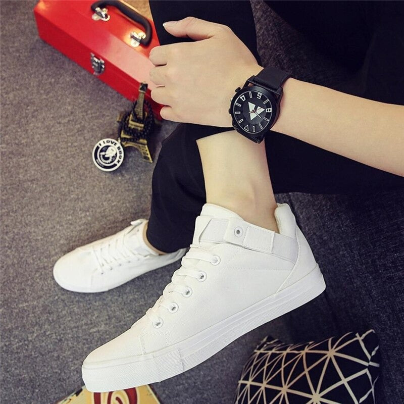 White breathable men's casual sneakers paired with stylish watch, perfect for street fashion.