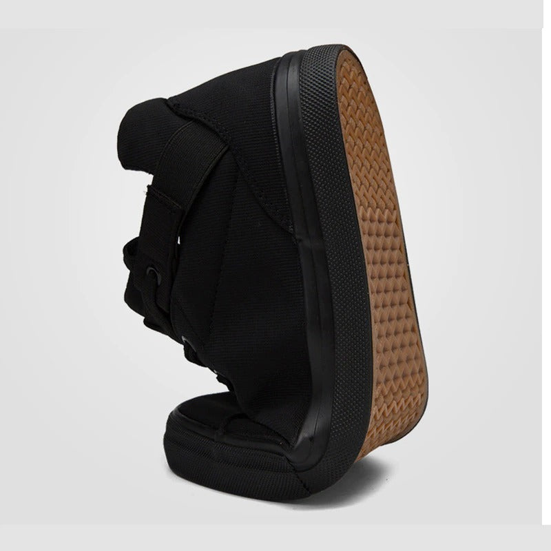 Breathable black canvas men's casual sneakers showcasing sleek design and textured sole for comfort.