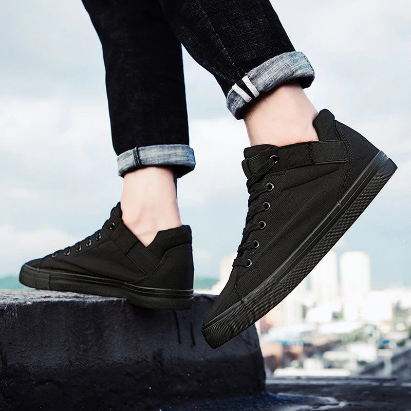 Stylish breathable black canvas sneakers for men, perfect for casual outings and street style. Comfortable lace-up footwear.