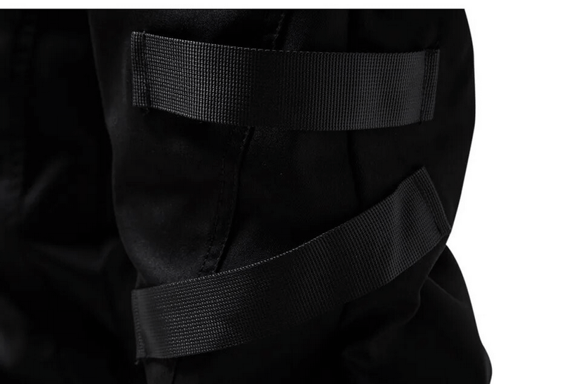 Close-up of black cargo pants showcasing stylish strap details for added functionality and fashion.